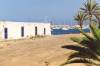 A reminder of days past - an old cottage by the sea, but now only yards from the hurly- burly